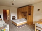 Wohnzimmer mit Schrankbett - 1-Zimmer-Eigentumswohnung in Hahnenklee